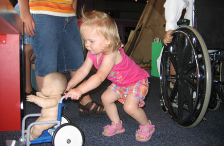 Pushing a baby around in a toy wheel chair was more fun than riding the real wheel chair